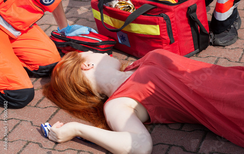 Unconscious girl lying on street