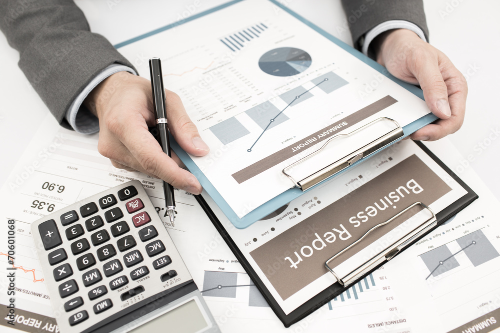 Close-up of graphs and charts analyzed by businessman Close-up of graphs and charts analyzed by businessman