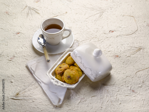 cookie with dried grape and cup of tea