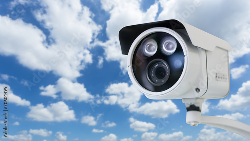 CCTV security camera on blue sky background
