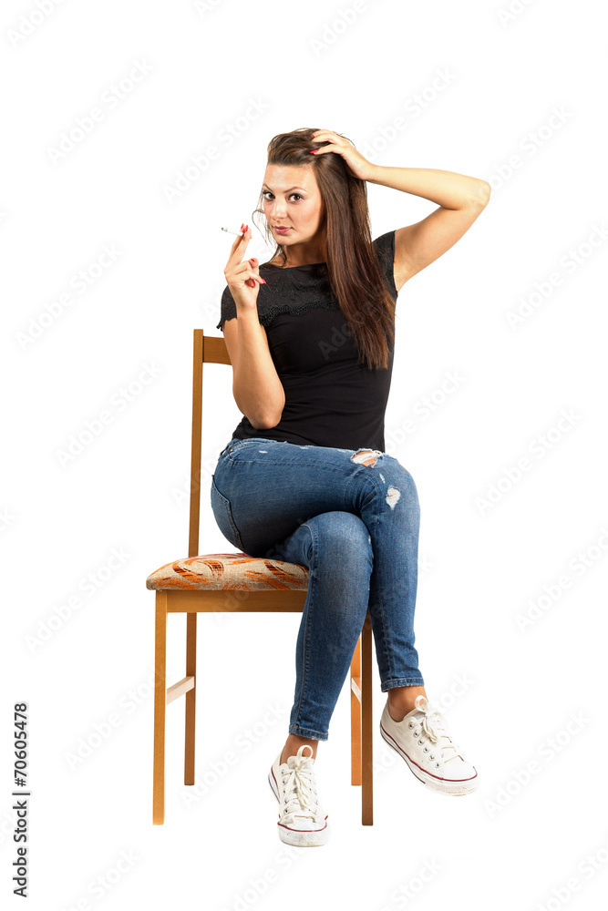 Sitting woman smoking cigarette looking at camera. Sitting woman smoking cigarette looking at camera.