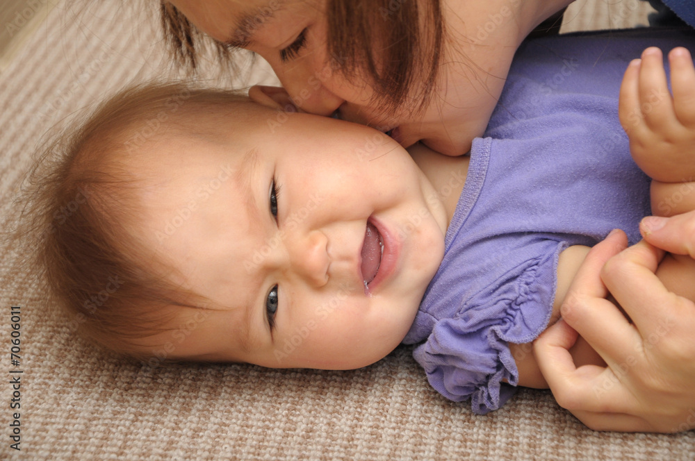 Happy baby smiling playing with mother Happy baby smiling playing with mother