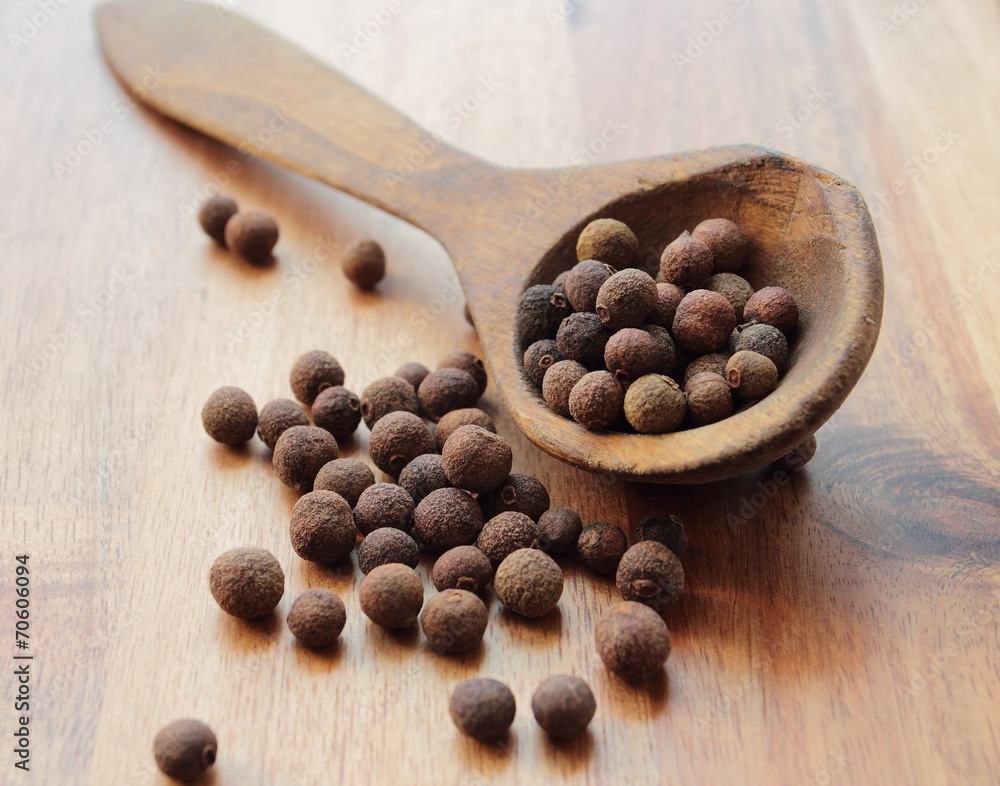 Aroma latin allspice peppers on a wooden spoon Aroma latin allspice peppers on a wooden spoon