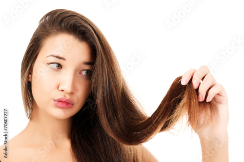 woman is not happy with her fragile hair, white background