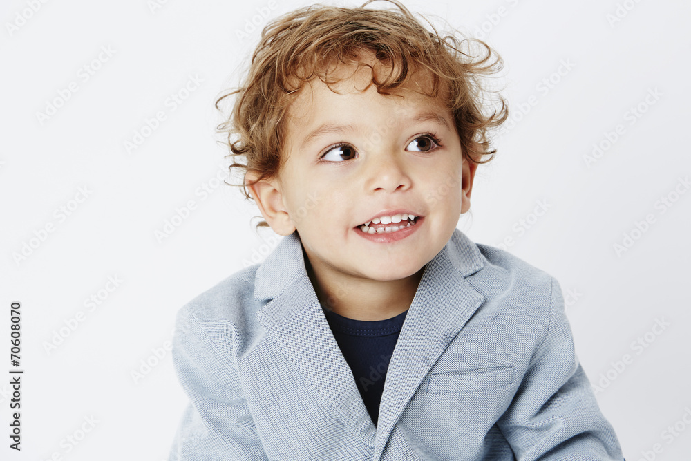 Smart two year old boy in suit looking away. Smart two year old boy in suit looking away.