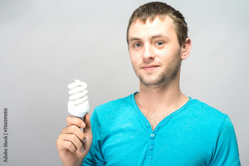 Portrait of a businessman holding a light bulb and smiling Portrait of a businessman holding a light bulb and smiling