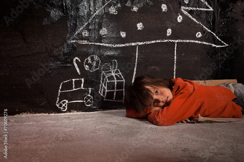 Poor kid on the street thinking of Christmas gifts
