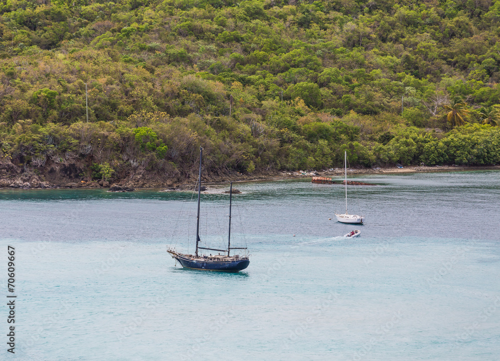 Fototapeta premium Old Blue Sailboat in Bay