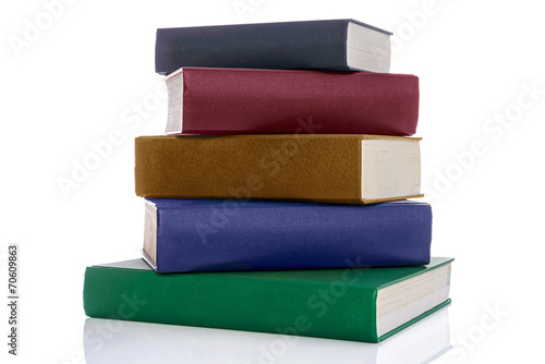 Stack of five hardback books isolated on white
