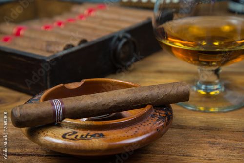 Cigars and Rum or alcohol on table