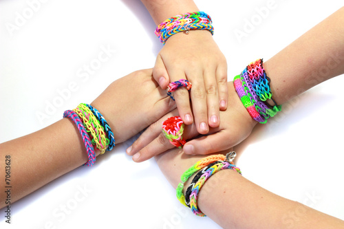 Elastic and colorful rainbow loom bracelet on hands © Patrycja