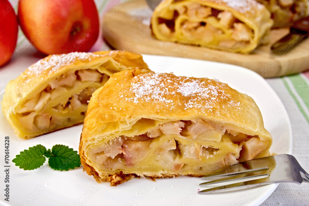 Strudel with apples in bowl on linen tablecloth Strudel with apples in bowl on linen tablecloth
