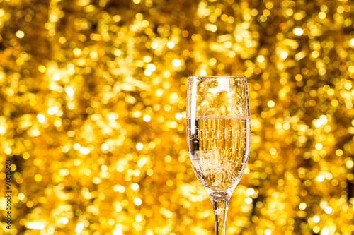 One champagne glass on christmas bokeh background ackground