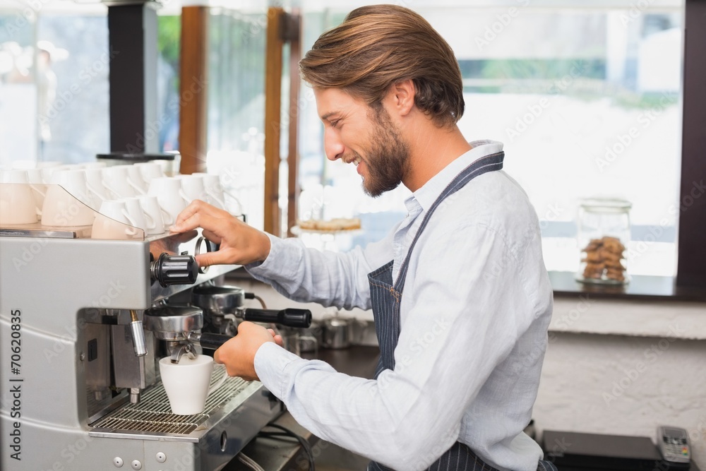 Handsome barista making a cup of coffee Handsome barista making a cup of coffee