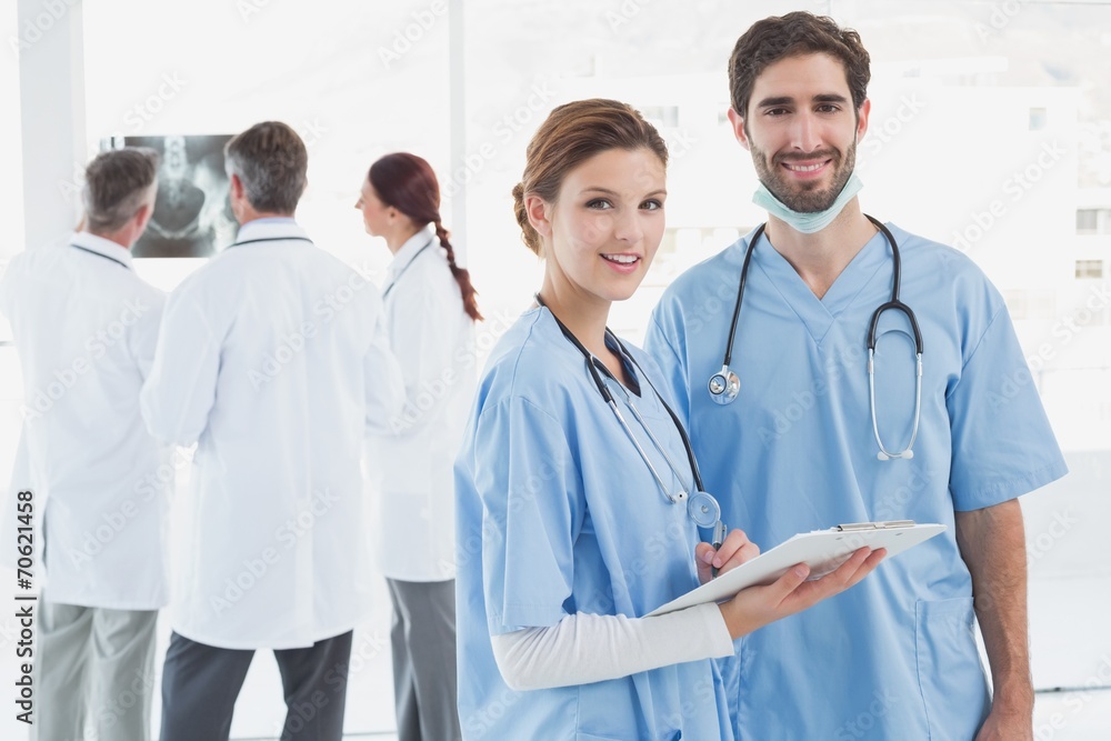 Nurses holding a file together Nurses holding a file together