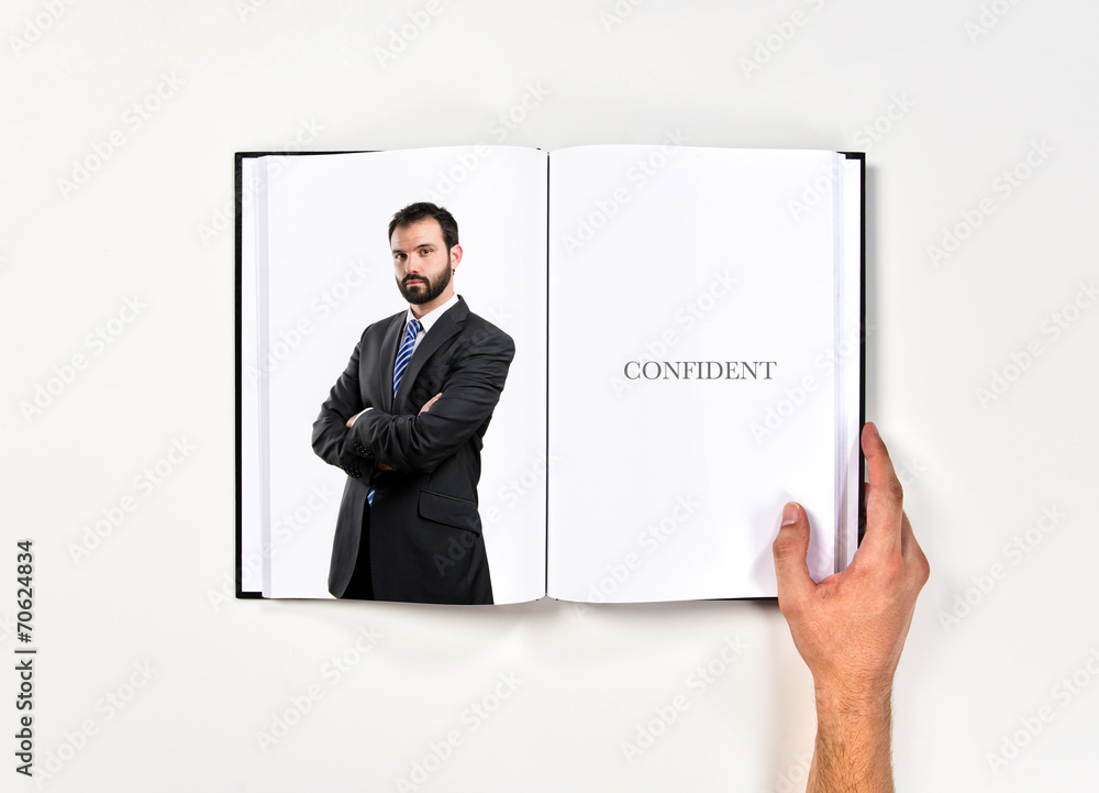 Business man with his arms crossed printed on book Business man with his arms crossed printed on book