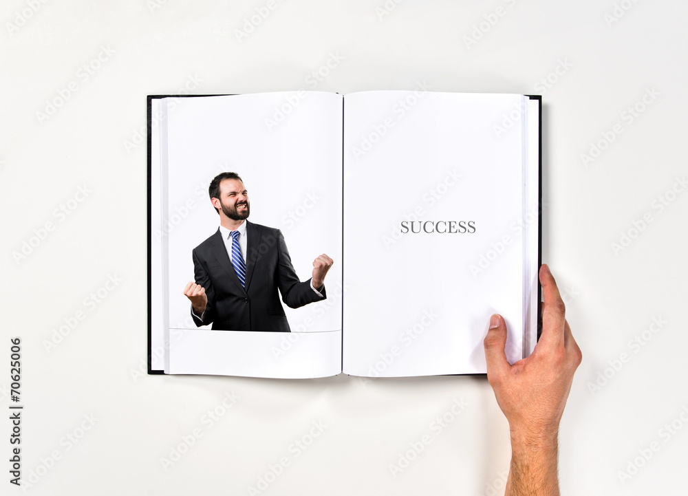 Young business man winner printed on book Young business man winner printed on book