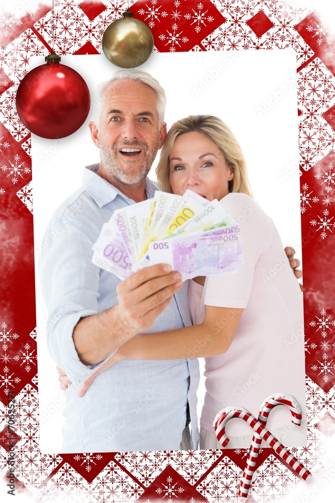 Composite image of happy couple flashing their cash Composite image of happy couple flashing their cash