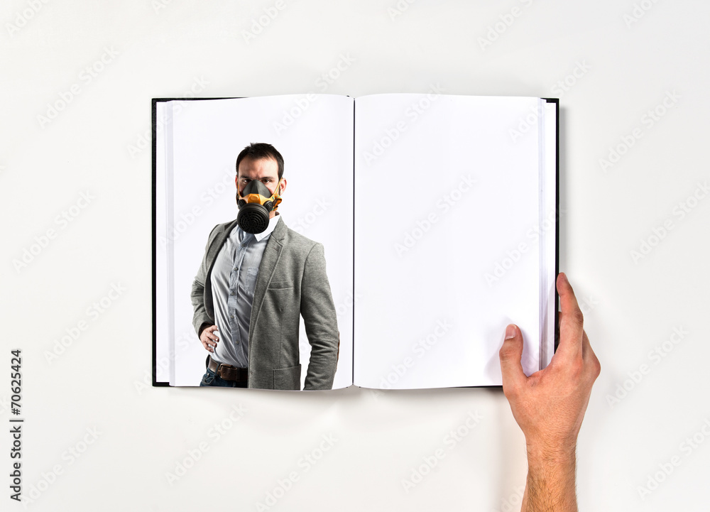 young businessman with gas mask printed on book young businessman with gas mask printed on book