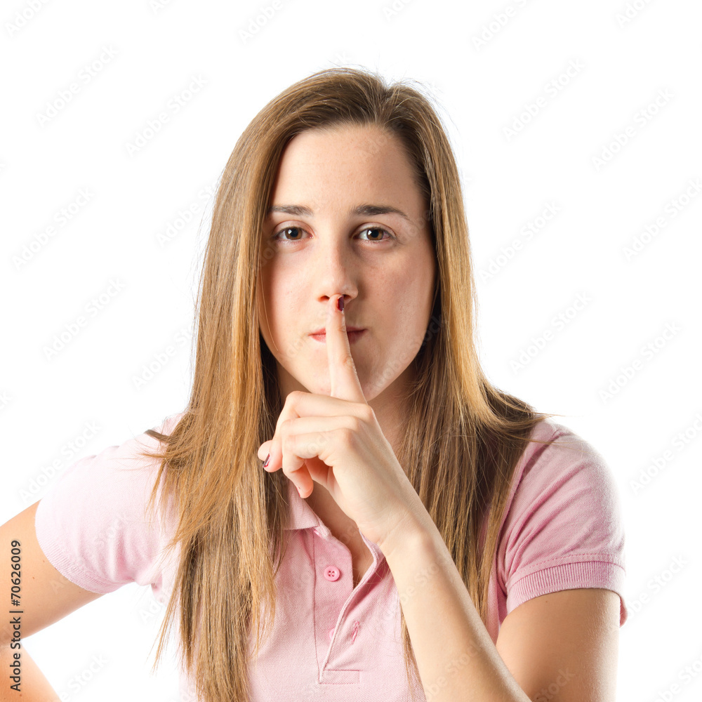 Naklejka premium Girl making silence gesture over isolated white background