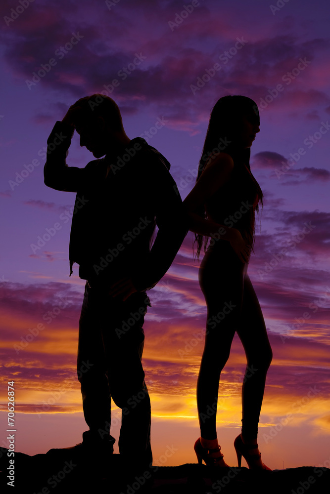 silhouette of couple back to back in the sunset