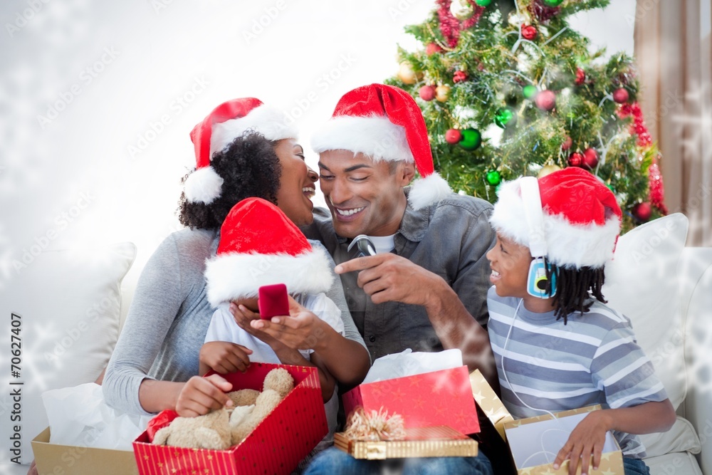 Happy family having fun with christmas presents Happy family having fun with christmas presents