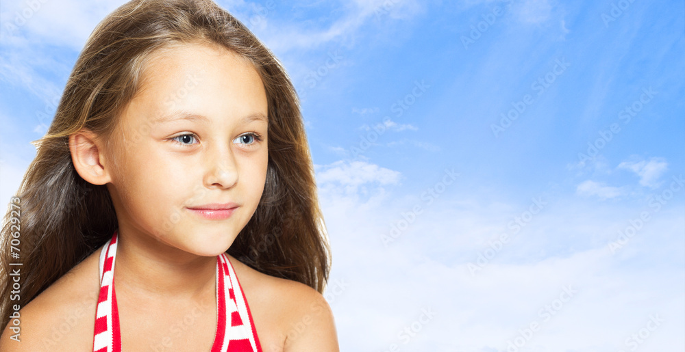 cheerful little girl on a background of blue sky cheerful little girl on a background of blue sky
