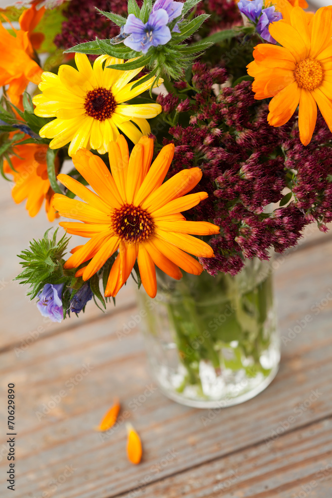 Bouquet of autumn flowers in vase on wooden background Bouquet of autumn flowers in vase on wooden background