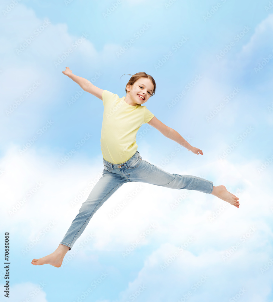 smiling little girl jumping