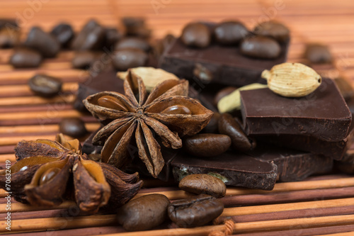 Close up of anise, cardamom with chocolate and coffee heap
