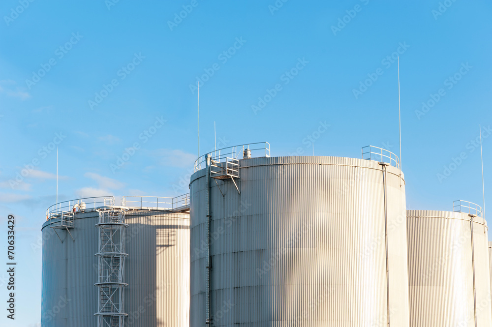 Three petrol tanks on blue sky background. Storage in Riga. Three petrol tanks on blue sky background. Storage in Riga.