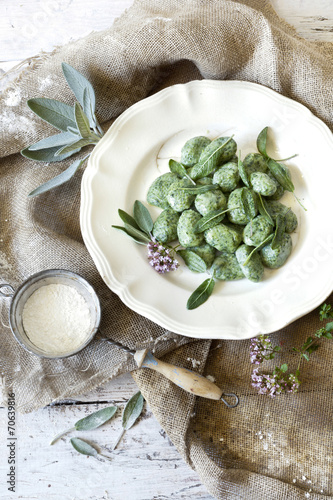 homemade spinach dumplings with sage leafs and flowers