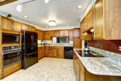 Beautiful kitchen interior with granite tops and black appliance