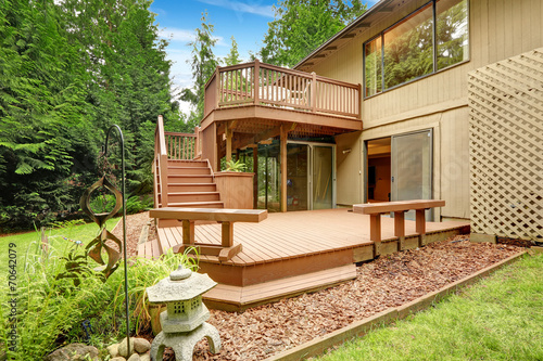 Wooden walkout deck with patio and benches photo