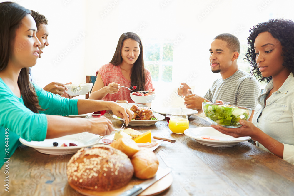 Group Of Friends Enjoying Meal At Home Together Group Of Friends Enjoying Meal At Home Together