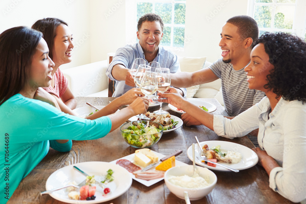 Group Of Friends Enjoying Meal At Home Together Group Of Friends Enjoying Meal At Home Together