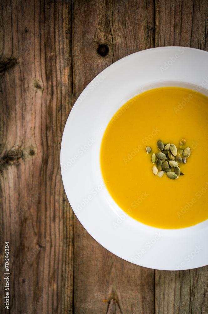 Pumpkin soup on wooden background Pumpkin soup on wooden background