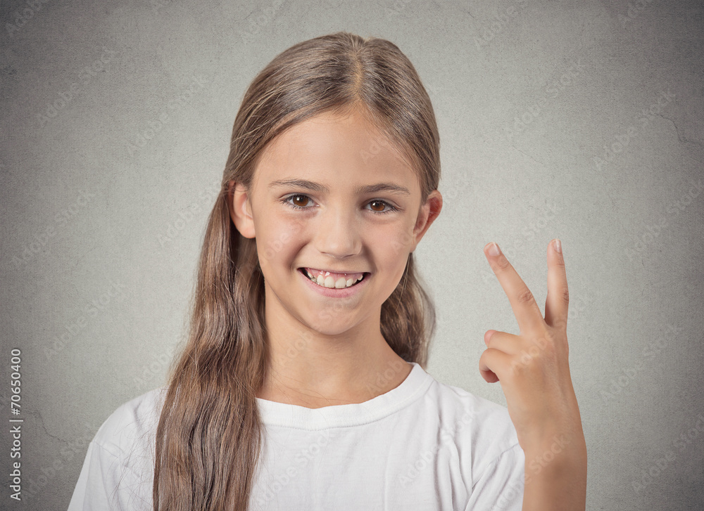 Headshot happy teenager girl giving number two, victory sign Headshot happy teenager girl giving number two, victory sign