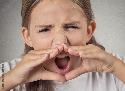 Headshot  furious angry teenager girl yelling screaming 