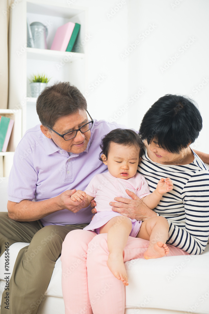 asian grand parents comforting their spoilt crying grand daugthe asian grand parents comforting their spoilt crying grand daugthe