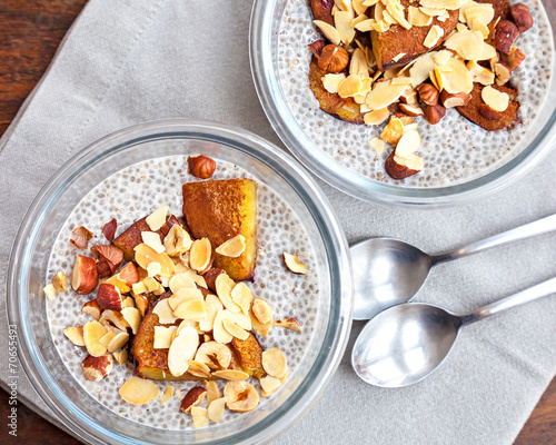 Vanilla chia seed pudding with baked prunes and nuts photo