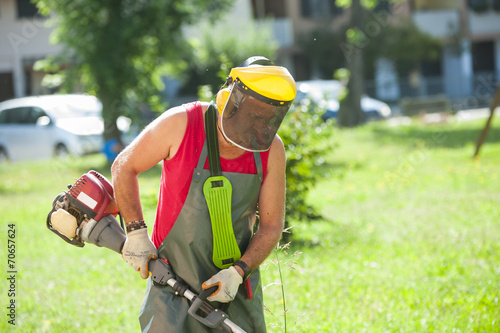 Man cutting grass with petrol mower