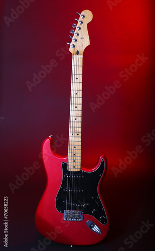 Red guitar on dark background
