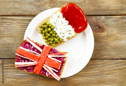 Sandwiches with  different flags on table close-up
