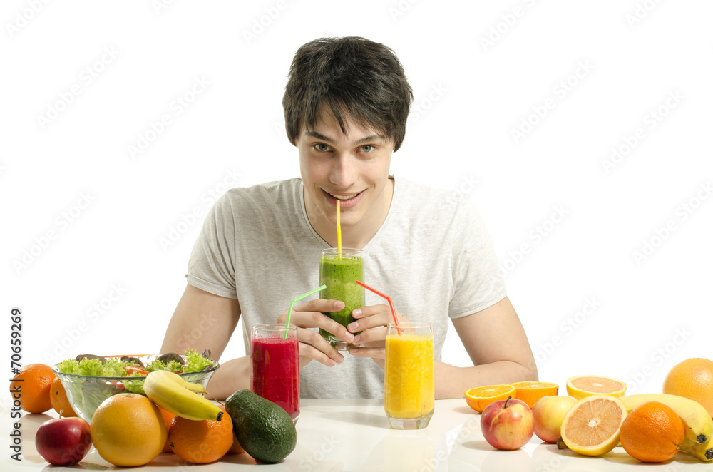 Man having a table full of organic food,juices, organic smoothie Man having a table full of organic food,juices, organic smoothie
