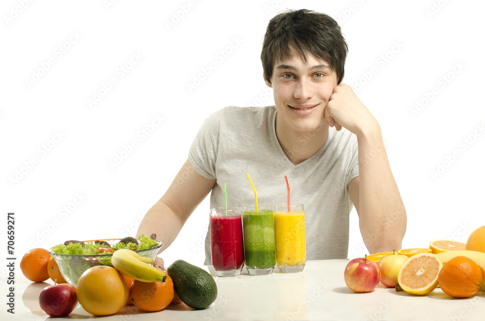 Man having a table full of organic food,juices, organic smoothie Man having a table full of organic food,juices, organic smoothie
