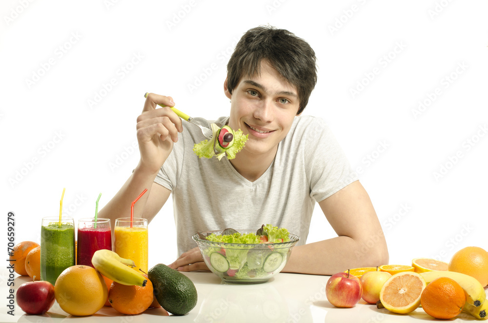 Man having a table full of organic food,juices, organic smoothie Man having a table full of organic food,juices, organic smoothie