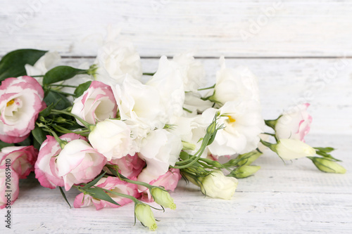 Beautiful eustoma flowers on wooden background