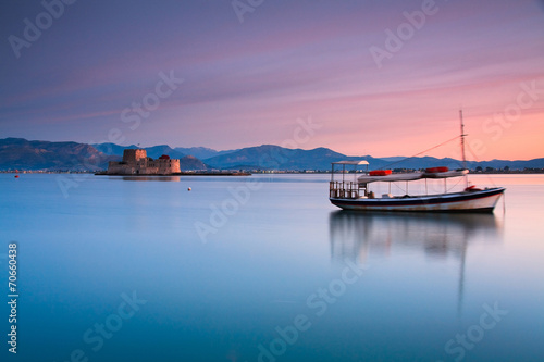 Boat and Burtzi castle in Nafplio, Greece. photo