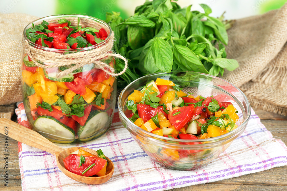 Vegetable salad in glass jar and bowl